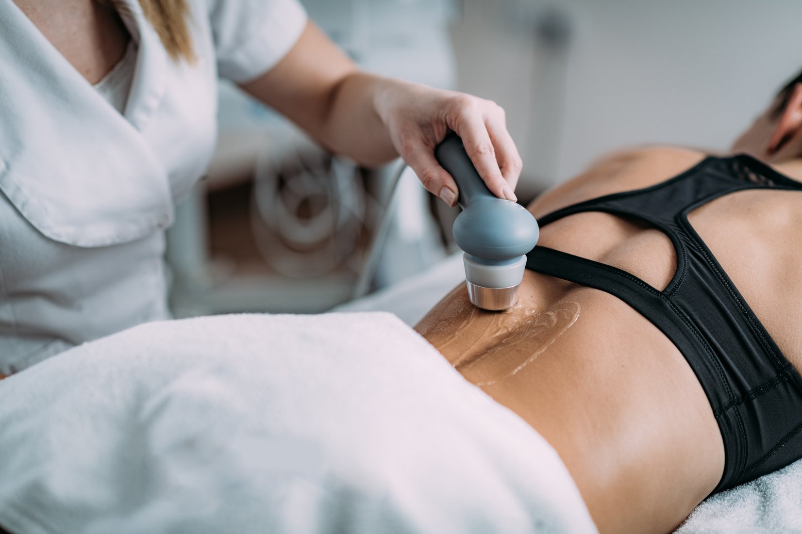 Ultrasound in Physical Therapy. Therapist Using Ultrasound Applicator on a Patient’s Lower Back
