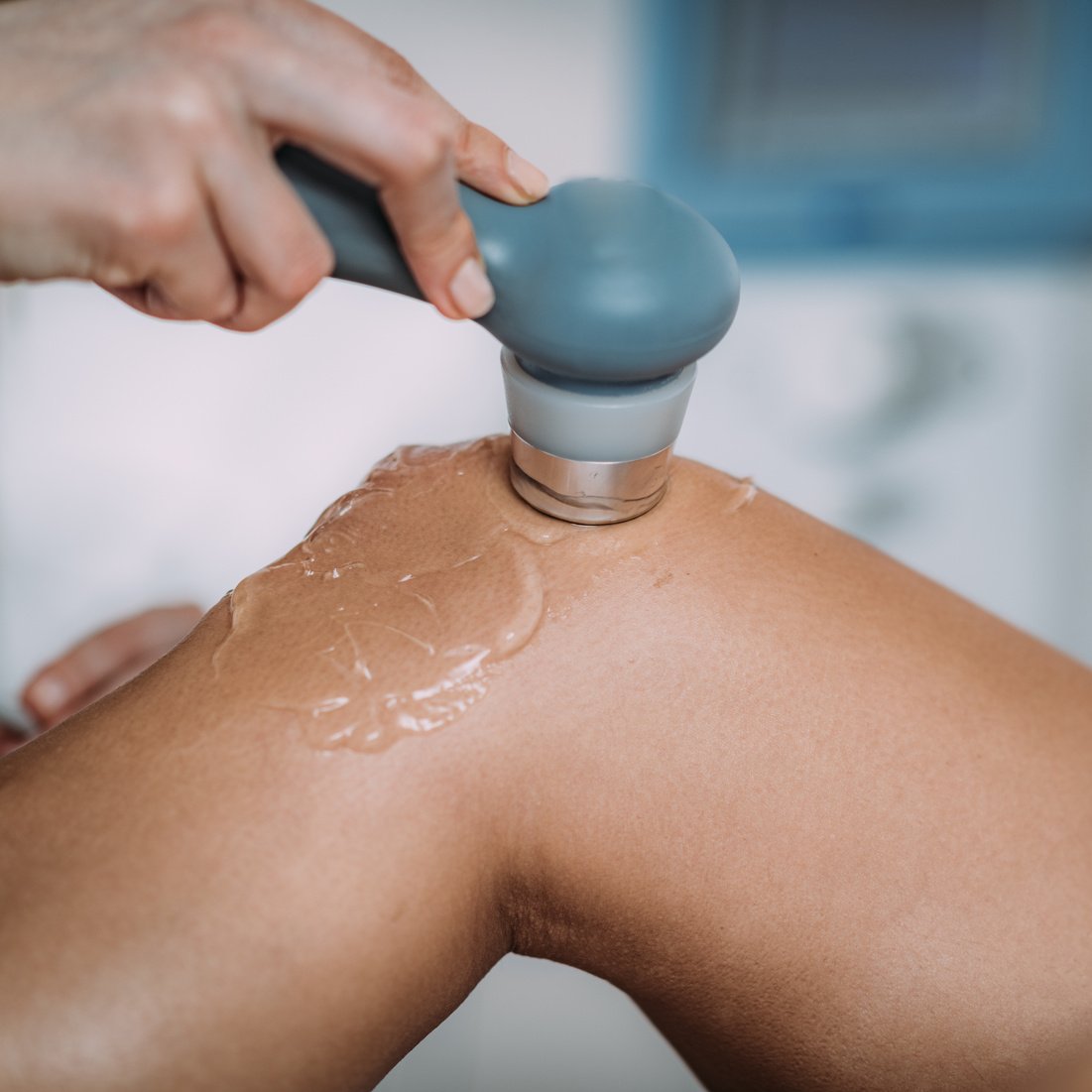 Ultrasound in Physical Therapy. Therapist Using Ultrasound Applicator on a Patient’s Knee